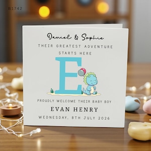 May include: A white square greeting card featuring the text Daniel & Sophie, THEIR GREATEST ADVENTURE STARTS HERE, a large light blue letter E, a cartoon dinosaur holding balloons, PROUDLY WELCOME THEIR BABY BOY, EVAN HENRY, WEDNESDAY, 8TH JULY 2026.