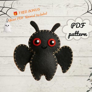 May include: A black felt bat plush toy with large red eyes and white pupils, featuring visible tan blanket stitching along the edges. The image includes text that reads FREE BONUS Ghost PDF Tutorial Included and PDF pattern.