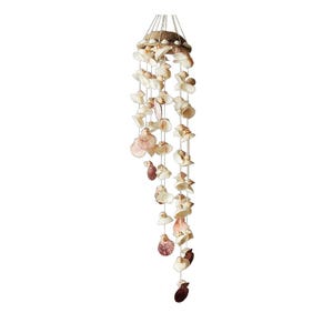 May include: A hanging seashell mobile with a natural, coastal theme. The mobile features various sizes and shapes of seashells in shades of white, beige, and brown, strung together with white string. The top is a cluster of shells, and the mobile hangs vertically.