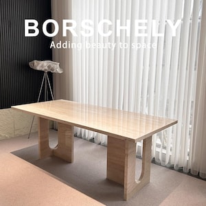 May include: A rectangular beige marble table with U-shaped legs. The table is in front of a window with white curtains. The text "BORSCHELY Adding beauty to space" is at the top of the image.