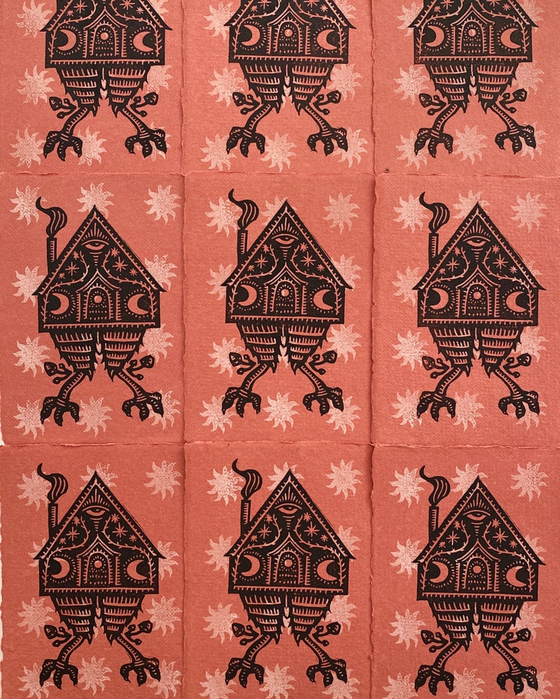 May include: Nine black and white illustrations of a house with a chimney and eyes, standing on two legs with feet. The house has a crescent moon and stars on the front. The background is a light pink with white stars.