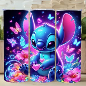 May include: A tumbler featuring a vibrant design of a blue cartoon character with large ears, surrounded by neon butterflies, hearts, and flowers. The background is a gradient of purple and pink, creating a whimsical and colorful aesthetic.