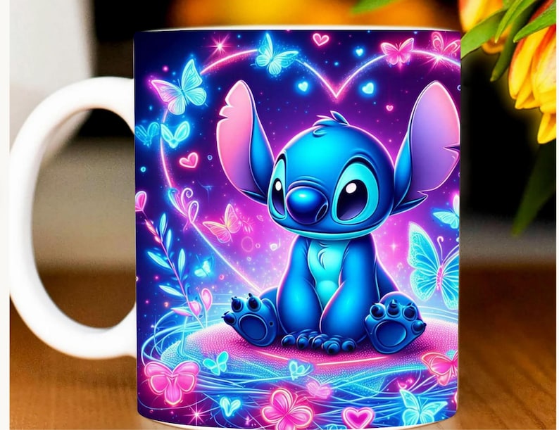 May include: A white ceramic mug featuring a vibrant illustration of the character Stitch from Lilo & Stitch. The design includes a blue Stitch surrounded by glowing butterflies, hearts, and floral elements in shades of pink, blue, and purple.