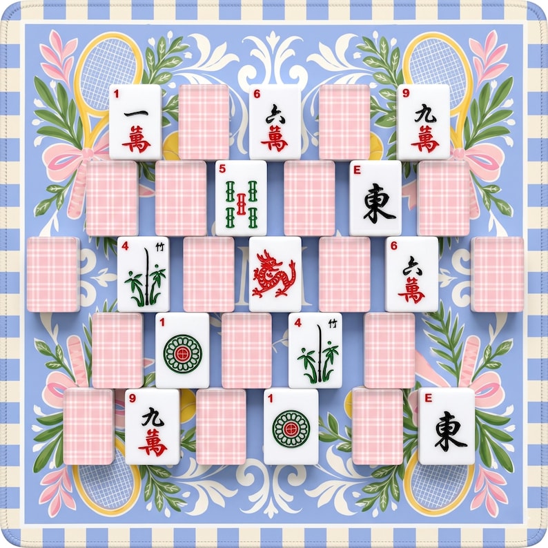 May include: A Mahjong set displayed on a blue and white patterned mat. The tiles feature Chinese characters and symbols in red, green, and black. Pink plaid tiles are interspersed between the game tiles. The mat has tennis rackets and floral designs.