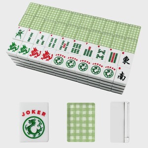 May include: A complete Mahjong set with white tiles featuring green and red dragon designs, numbers, and Chinese characters. The set includes green checkered card-like pieces and a white case.