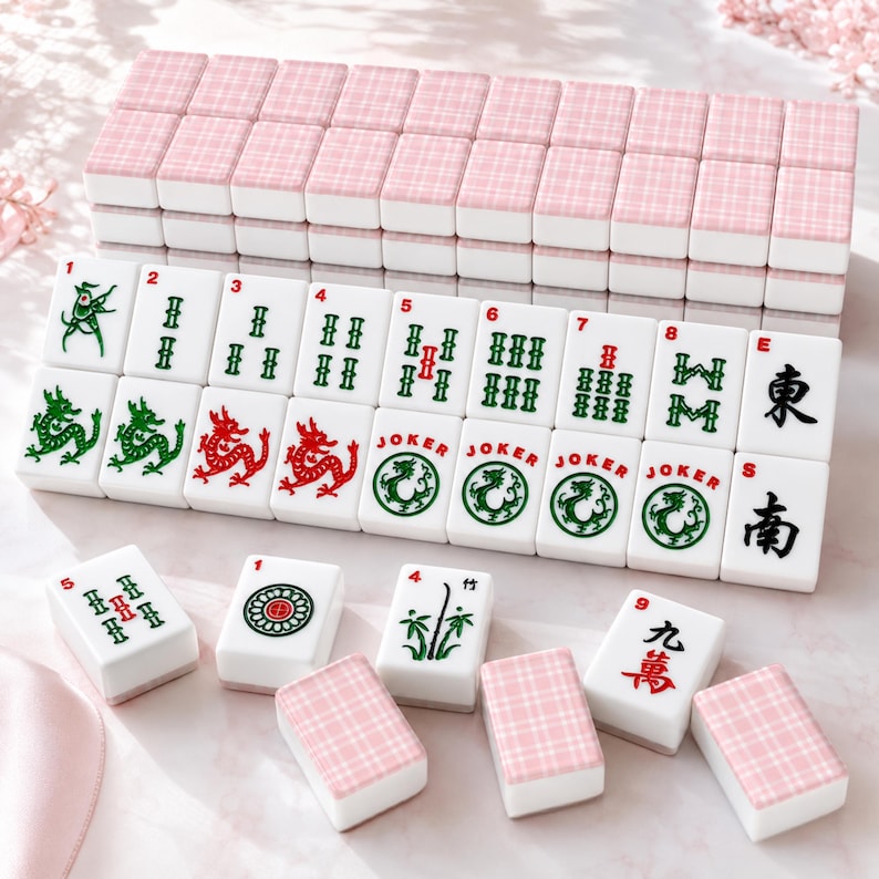May include: A Mahjong set with white tiles displaying numbers, symbols, and Chinese characters. The tiles are arranged on a surface, some stacked and others displayed. The tops of the tiles have a pink plaid pattern.