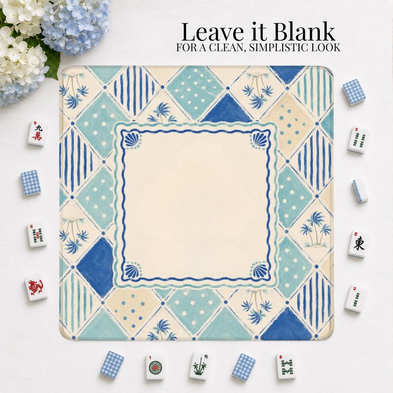 May include: Square decorative mat with a blue and cream geometric pattern, featuring a central blank cream-colored square. The mat is surrounded by Mahjong tiles and the text "Leave it Blank" is at the top.
