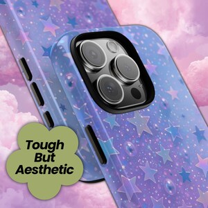 May include: Aesthetic phone case with a purple and blue starry design. The case features a black camera ring and the text "Tough But Aesthetic" in a green flower-shaped graphic.