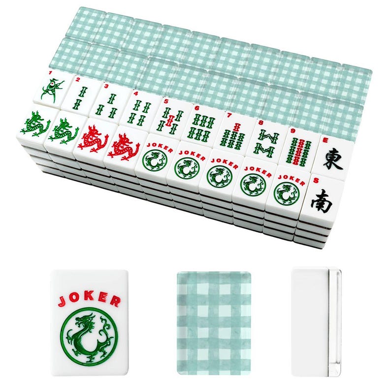 May include: A complete Mahjong set with white tiles featuring red and green dragon designs, numbers, and Chinese characters. The set includes a stack of tiles and a light blue checkered mat.