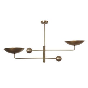 May include: A brass-toned, modern chandelier with a central vertical rod and horizontal arms. Two bowl-shaped shades and two spherical accents are positioned along the arms. The fixture is designed for ceiling mounting.
