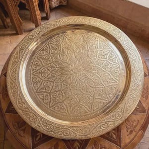 "Moroccan brass tray used as a decorative table topper in a boho living room."