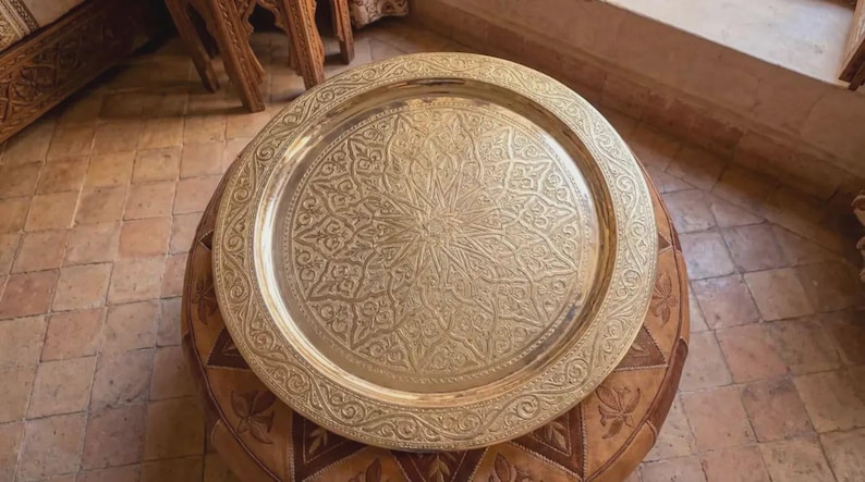 "Moroccan brass tray used as a decorative table topper in a boho living room."