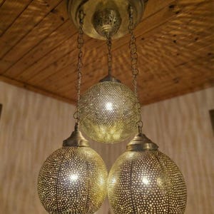 Wide shot of a Moroccan light fixture as a center piece in a modern bohemian home.