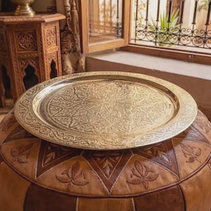 "Side profile showing the raised edge and thickness of the solid brass tray."