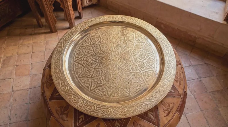 "Golden Moroccan tray catching the sunlight in a bright, airy room."