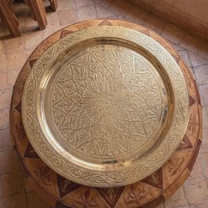 "Close-up of hand-etched Arabesque details on a gold brass serving platter."