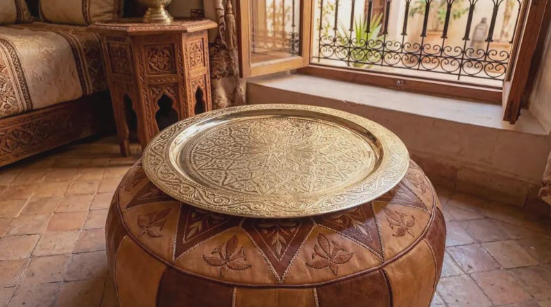 "Large round Moroccan brass tray with intricate hand-engraved geometric patterns."