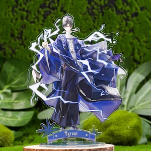 May include: An acrylic figure of a character in a blue and black outfit, holding a staff and surrounded by lightning bolts. The figure stands on a wooden base with the word "Tyrant" on a banner.