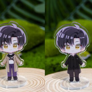 May include: Two acrylic anime-style character figures. One figure wears a tan coat, purple pants, and black shoes. The other figure is dressed in a black suit. Both have black hair and yellow eyes, standing on clear bases.