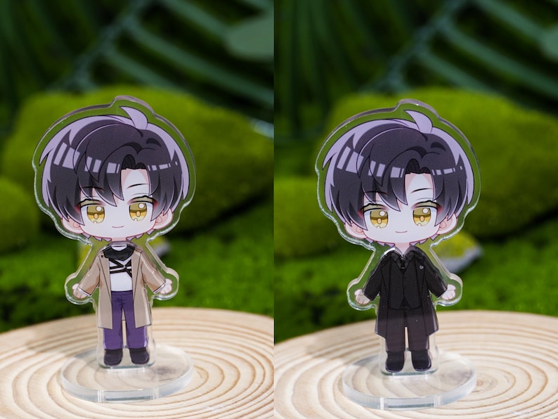 May include: Two acrylic anime-style character figures. One figure wears a tan coat, purple pants, and black shoes. The other figure is dressed in a black suit. Both have black hair and yellow eyes, standing on clear bases.