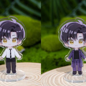 May include: Two acrylic anime-style figures of a male character with black hair and yellow eyes. One figure wears a white shirt, black pants, and a tie. The other figure wears a purple suit. Both figures stand on clear circular bases.
