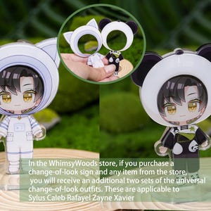 May include: Two acrylic figurines of a character in different outfits: a white cat-themed astronaut suit and a black and white panda suit. The figurines are on clear stands, with a small inset image of the outfits as keychains.