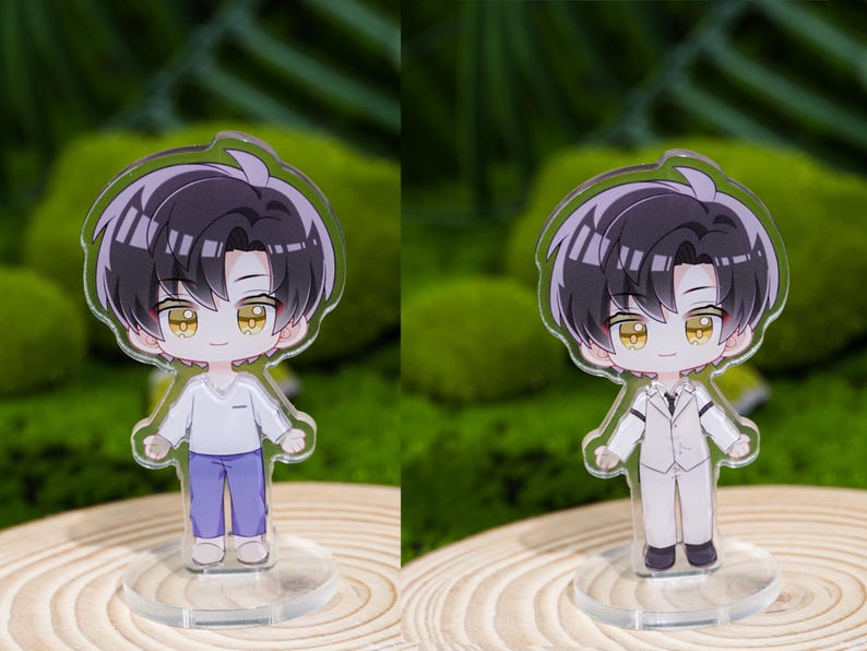 May include: Two acrylic anime-style figures of a male character with black hair and yellow eyes. One figure wears a white shirt and purple pants, the other wears a white suit. Both figures stand on clear circular bases.