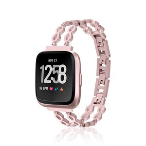 May include: A rose gold smartwatch with a black screen displaying the time, date, and heart rate. The watch band is a matching rose gold metal link design. The watch face shows "NOV 23" and "12:58".