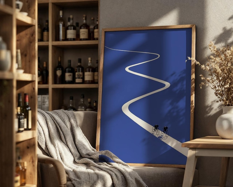 Minimalist illustration of two cyclists on a white winding road over a solid blue background, emphasizing movement and endurance.