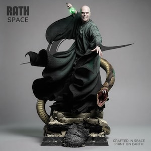 May include: A detailed statue of a bald figure in dark green robes, holding a glowing green object. A large snake with a detailed pattern is coiled around the base. The statue is on a stone-like base. The text "RATH SPACE" is visible.