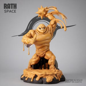 May include: A tan-colored statue of a muscular, smiling figure holding a spiked ball and a metallic object. The figure is posed on a dark, textured base. The text "RATH SPACE" and "CRAFTED IN SPACE PRINT ON EARTH" are visible.
