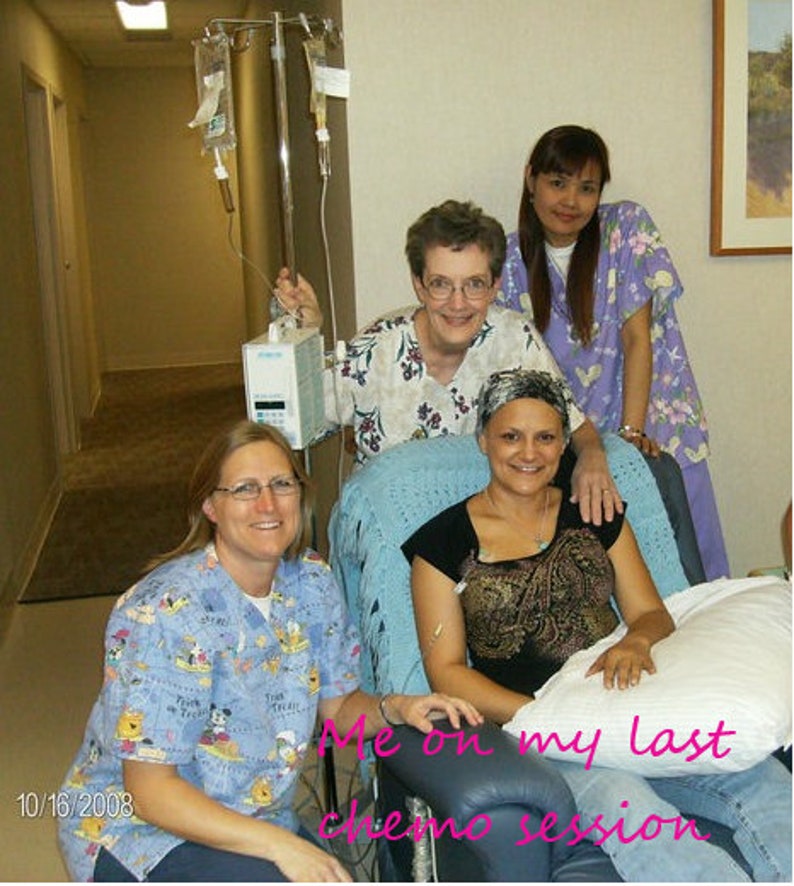 Puede incluir: Una mujer en una cama de hospital con una manta azul y una almohada. Lleva una camisa con estampado negro y dorado y una cubierta de cabeza blanca. Dos mujeres m&aacute;s est&aacute;n de pie detr&aacute;s de ella, una con una camisa morada y la otra con una camisa blanca y azul. El texto "Me on my last chemo session" est&aacute; escrito en la imagen.