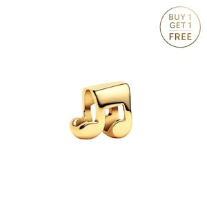 May include: A gold-colored charm in the shape of a musical eighth note. The charm is smooth and shiny, with rounded edges. The background is white, and a gold circle with the text "BUY 1 GET 1 FREE" is in the upper right corner.