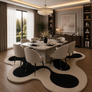 May include: A modern dining room featuring a square marble table set for a meal, surrounded by beige upholstered chairs with black legs. A unique rug with black and beige organic shapes sits beneath the table. A large chandelier hangs above.