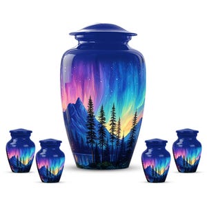 May include: A collection of blue cremation urns with a painted landscape design. The artwork depicts mountains, trees, and an aurora borealis in shades of purple, blue, and yellow. The set includes a large urn and several smaller keepsake urns.