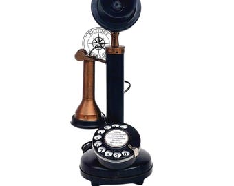 Teléfono antiguo de estilo retro vintage, color cobre y negro, con disco giratorio, en funcionamiento, pieza de decoración para el hogar.