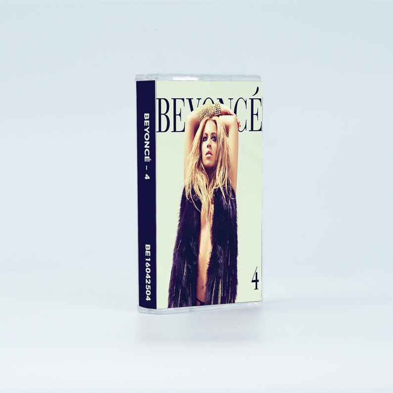 May include: A cassette tape featuring the album 4 by Beyonc&eacute;. The cover art displays a person with long blonde hair wearing a dark faux fur vest against a light green background. The text BEYONC&Eacute; is printed at the top, with 4 on the side and front.