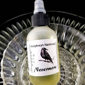 May include: A glass bottle with a black cap and a white label. The label has a black raven illustration and the text "Humphrey's Handmade Beard Oil Nevermore".