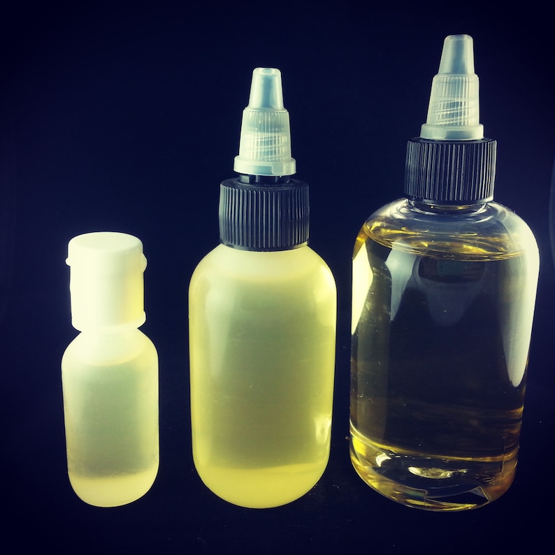 May include: Three clear glass bottles with droppers, two with black caps and one with a white cap. The bottles are filled with a light yellow liquid.