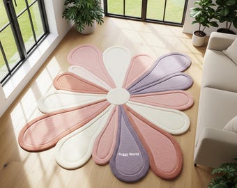 May include: A flower-shaped area rug featuring a central circular white core surrounded by elongated petals in alternating shades of soft pink, cream, and muted purple. The text Ruggy World is printed in white on one of the purple petals.