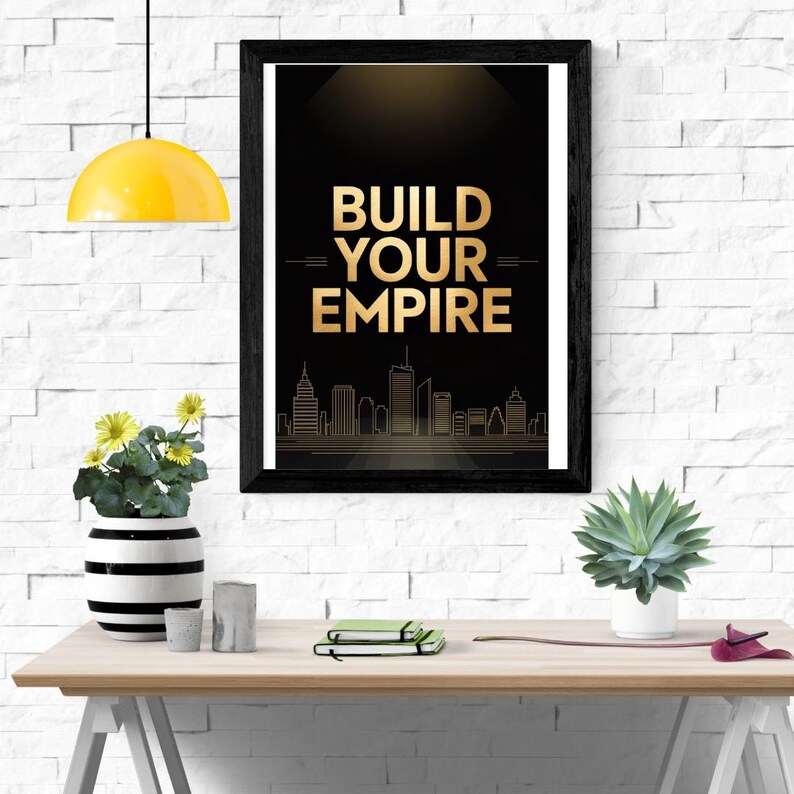 May include: A framed wall art print featuring a black background with the gold text BUILD YOUR EMPIRE centered above a gold line-art city skyline. The print is displayed in a black frame, showcasing a motivational design with a dark aesthetic.