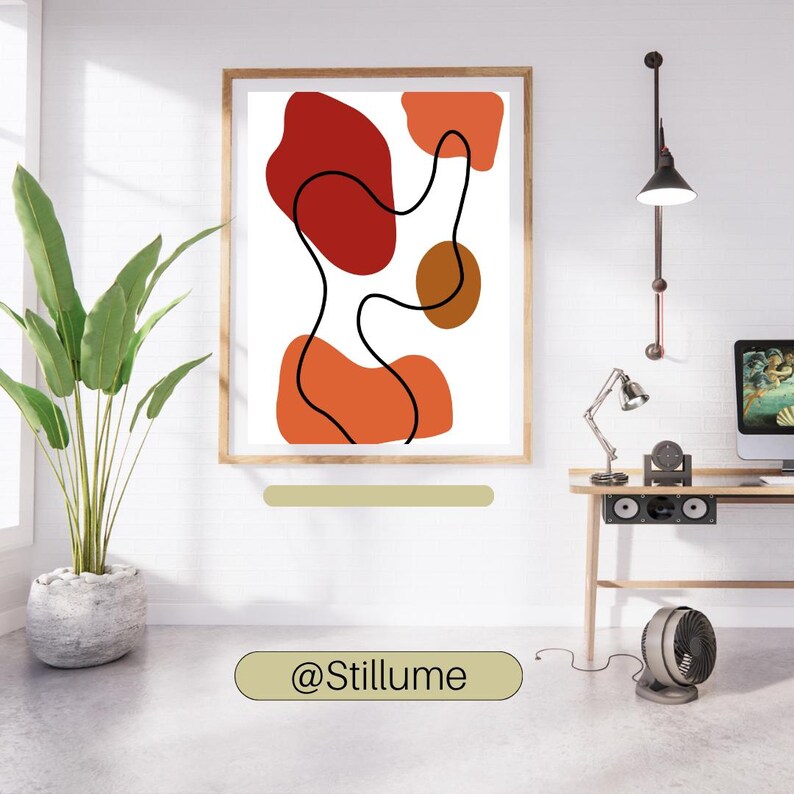 Puede incluir: Una impresi&oacute;n de arte mural enmarcada que presenta una composici&oacute;n abstracta de formas org&aacute;nicas en tonos rojos, naranjas y marrones, atravesada por una l&iacute;nea negra continua sobre un fondo blanco. El texto @Stillume es visible bajo el marco.