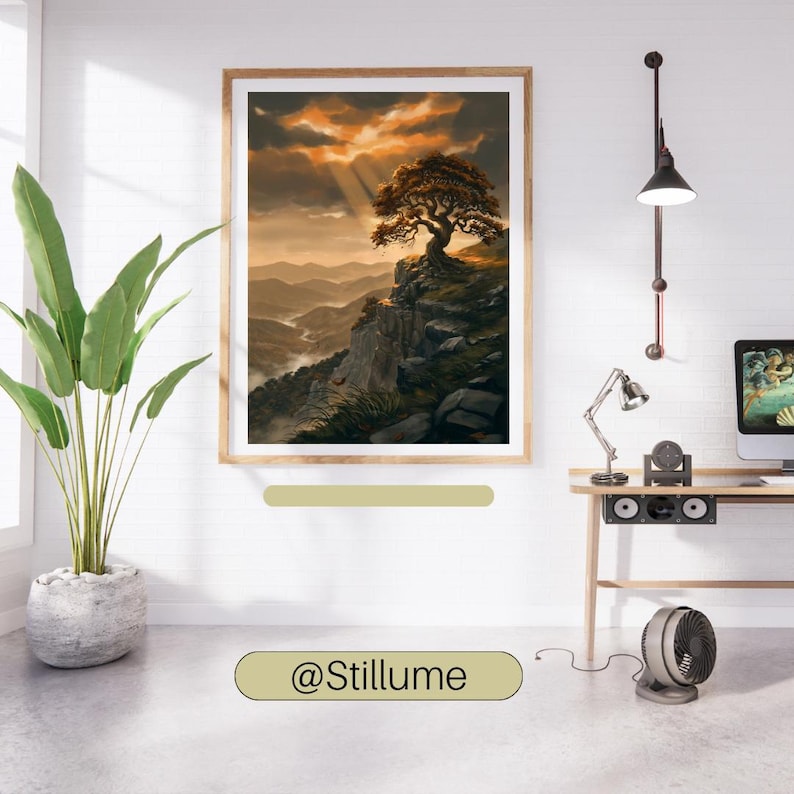 May include: A framed landscape wall art print featuring a solitary tree perched on a rocky cliff overlooking a misty mountain valley at sunset with golden light rays breaking through dark clouds. The text @Stillume is visible below the frame.