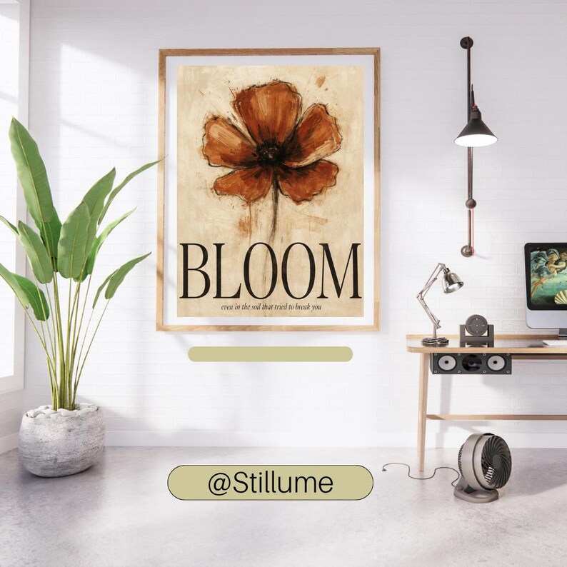 May include: A rectangular wall art print featuring a large, painterly rust-orange flower centred on a beige background. The word BLOOM is printed in large black serif letters below the flower, with the text even in the soil that tried to break you.