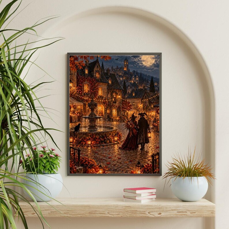 May include: A framed wall art print depicting a nighttime autumn village scene with a central stone fountain, glowing lanterns, fallen orange leaves, and two figures walking on a cobblestone path under a full moon and a starry night sky.