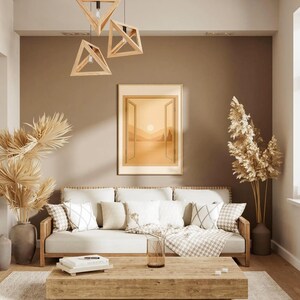 May include: A living room scene with a neutral color palette. A light-colored sofa with decorative pillows sits beneath a framed landscape painting. Wooden geometric pendant lights hang above a wooden coffee table.