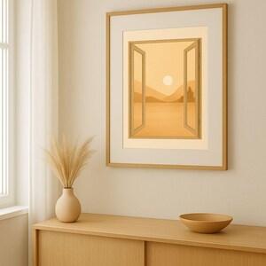 May include: A framed artwork depicts a serene landscape scene through an open window, with a warm, golden color palette. A vase with dried pampas grass and a wooden bowl sit on a wooden cabinet. A window with a white curtain is visible.