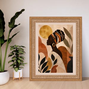 May include: A framed wall art print featuring a profile illustration of a person wearing a patterned headwrap and a large gold hoop earring. The artwork displays a warm colour palette of gold, terracotta, and black, with abstract shapes and foliage.