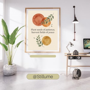 May include: A framed wall art print featuring a cream background with three watercolour circles in shades of orange and gold, accented by green leafy branches. The text reads: Plant seeds of patience, harvest fields of peace. The brand name @Stillume is visible.