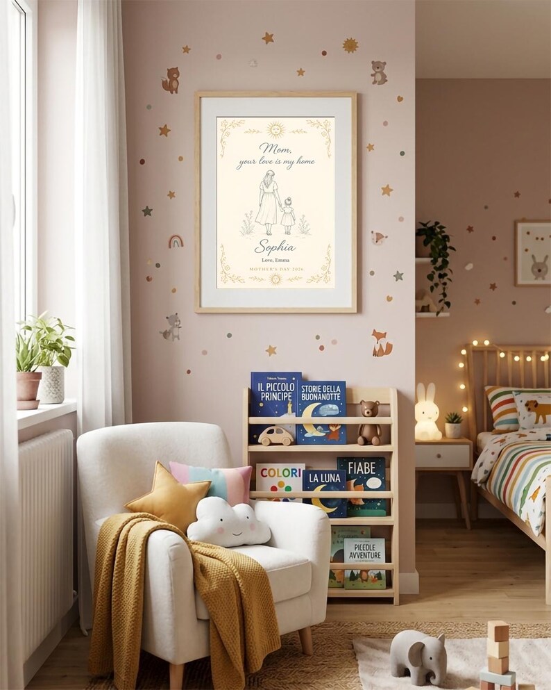 May include: A framed print with the text "Mom, your love is my home" and the name "Sophia". The artwork depicts a mother and child. The room has a white armchair, a bookshelf with children's books, and decorative wall stickers.
